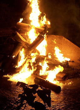 Ethanol tank cars burn as they dangle off of a Pennsylvania railroad bridge